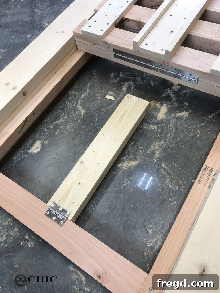 Installing the utility hinge to connect the adjustable arm to the hinge board of the DIY outdoor lounge chair, ensuring smooth backrest movement.