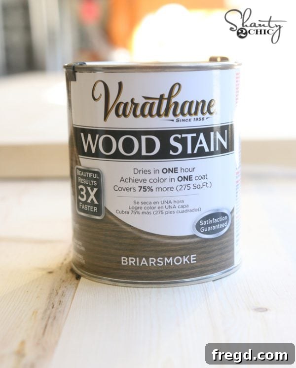 Applying Briarsmoke stain to a wooden lounge chair, enhancing its natural grain and providing an elegant finish for outdoor use.