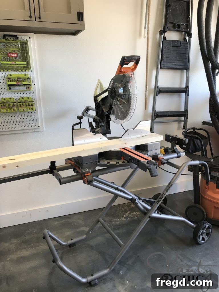 Woodworker using a miter saw to accurately cut lumber for the DIY outdoor lounge chair, ensuring precise dimensions for each piece.