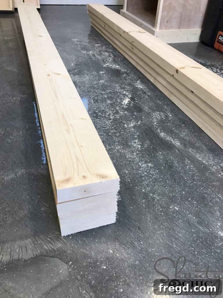 Arrangement of four 2x6 lumber boards stacked precisely on top of each other, forming the base of a sturdy side panel for the outdoor lounge chair.