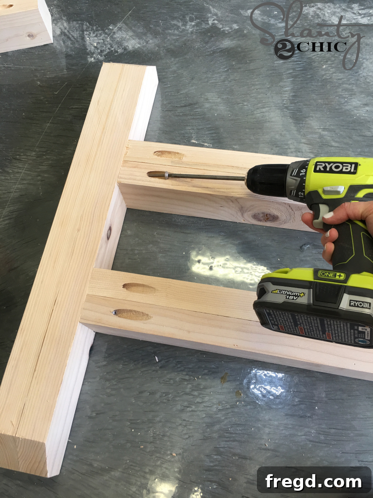 Attaching the Stretchers: assembling the cross members that provide stability to the table base.