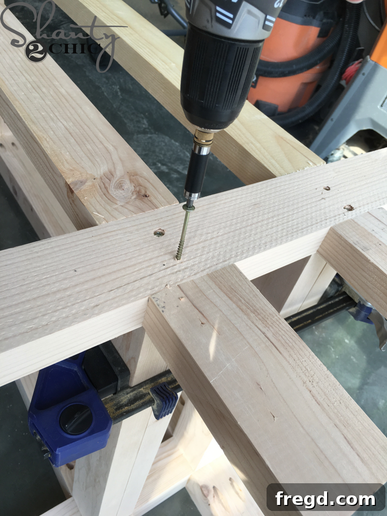 Attaching the Top of the Base to the Legs securely with screws.