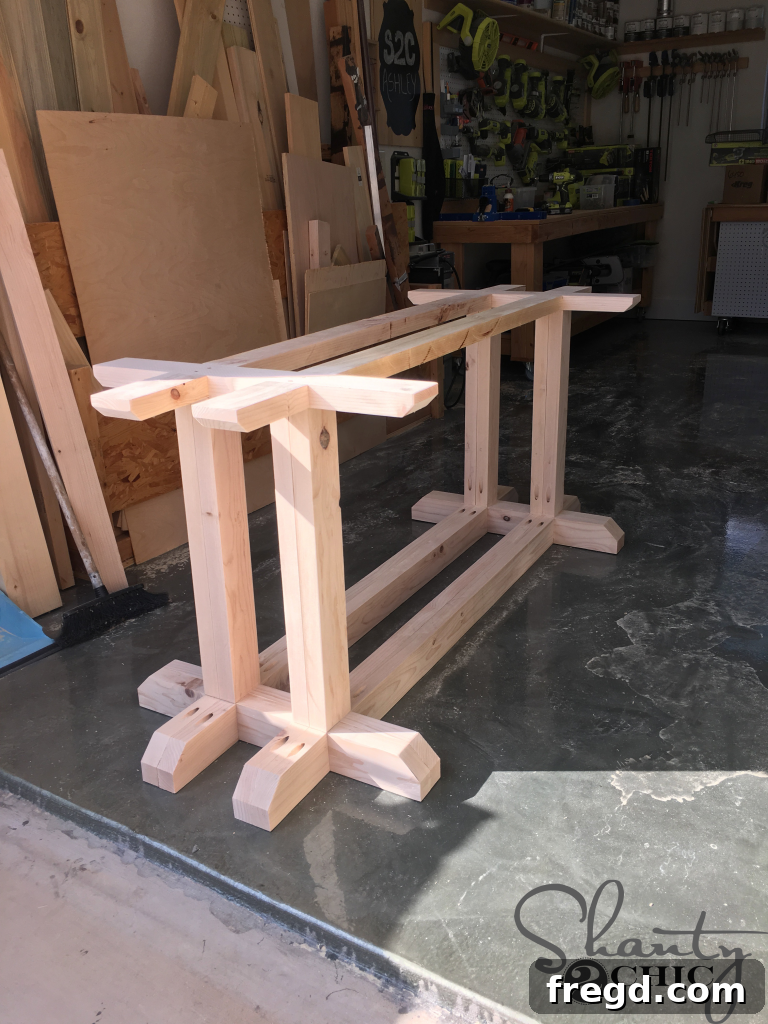 DIY Industrial Corbel Farmhouse Table with assembled base, showcasing the chic design.