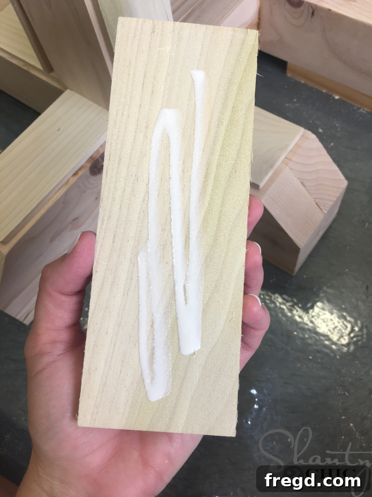 Applying Wood Glue on the Trim pieces before securing them to the table base.