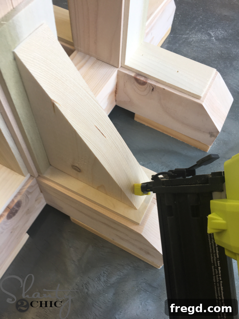 Attaching the Corbels to the table base using wood glue and brad nails.
