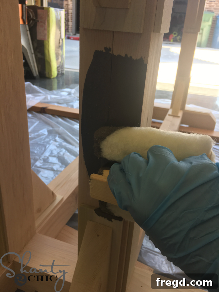 Applying Stain to a Dining Table evenly using a lamb's wool applicator.