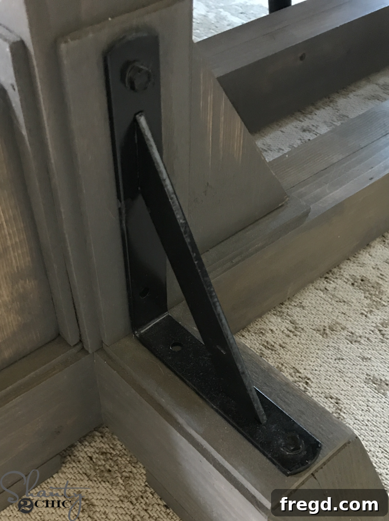 Attaching the Metal Corbels to the DIY dining table for an industrial look.