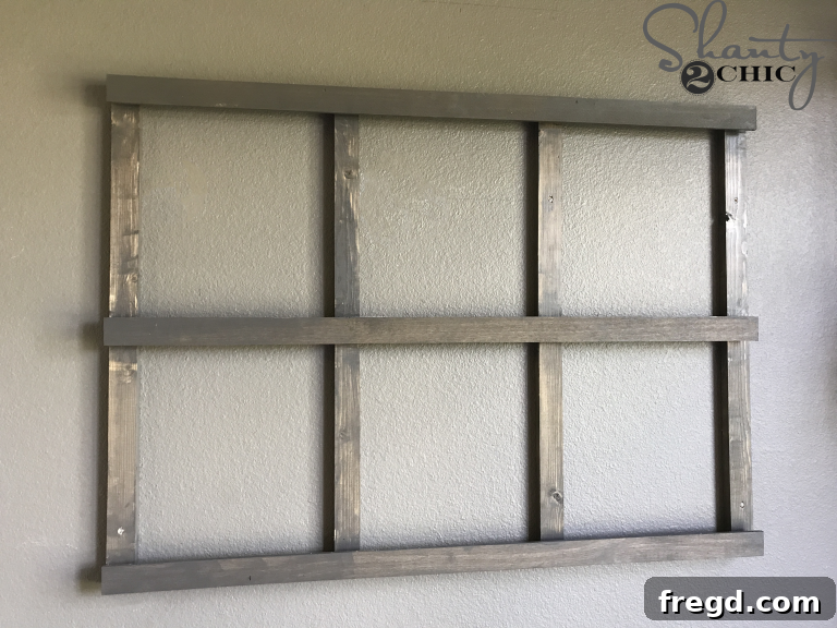 Securing the organizer frame to the wall with screws