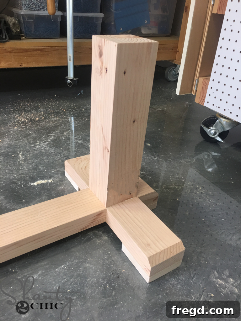 Attaching foot pads to the bench base using a nail gun and brad nails
