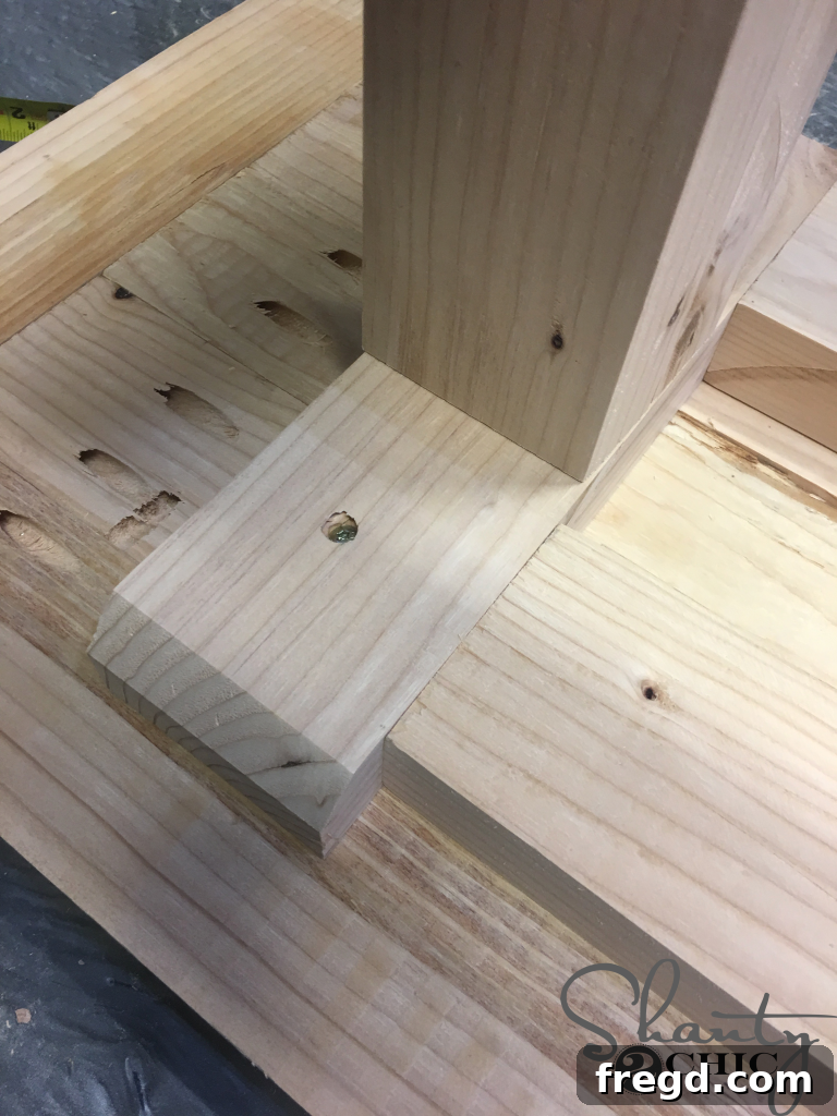 Attaching the planked bench top to the bench base from underneath
