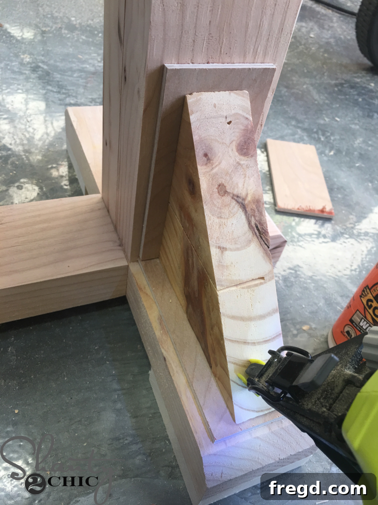 Layering additional craft boards on top of the bottom ones, against the legs