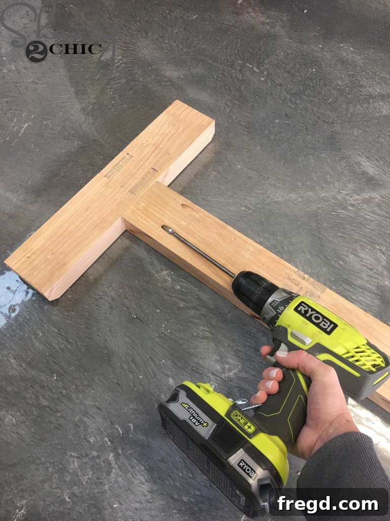 Drilling 1 1/2 inch pocket holes into the ends of the bottom runner using a Kreg Jig
