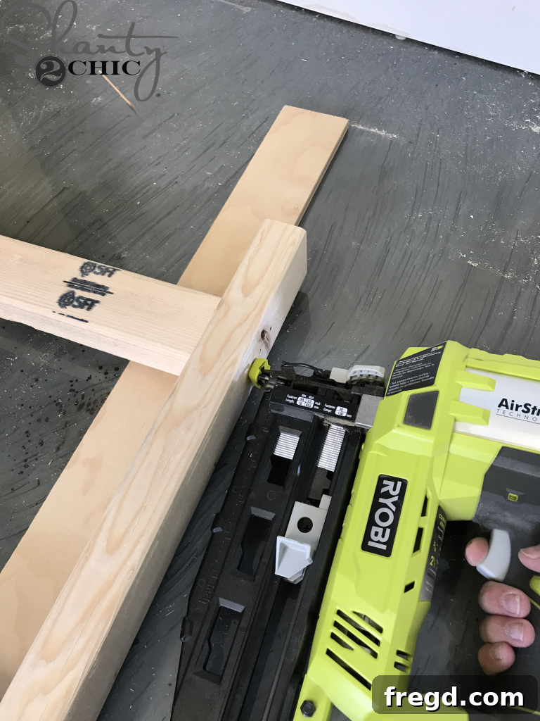 Assembling the rungs on a rustic blanket ladder with glue and nails