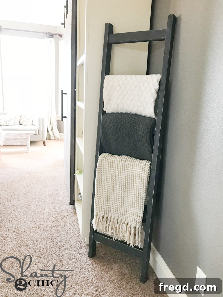 Stylish display of blankets on a DIY wood ladder