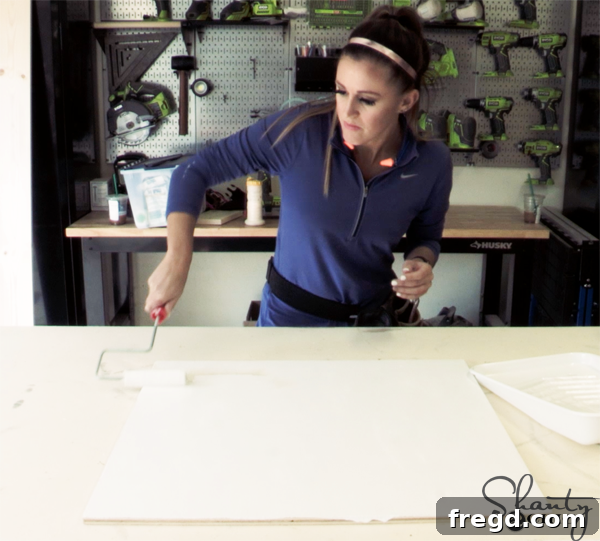 Preparing plywood for a DIY cow print project, showing initial setup