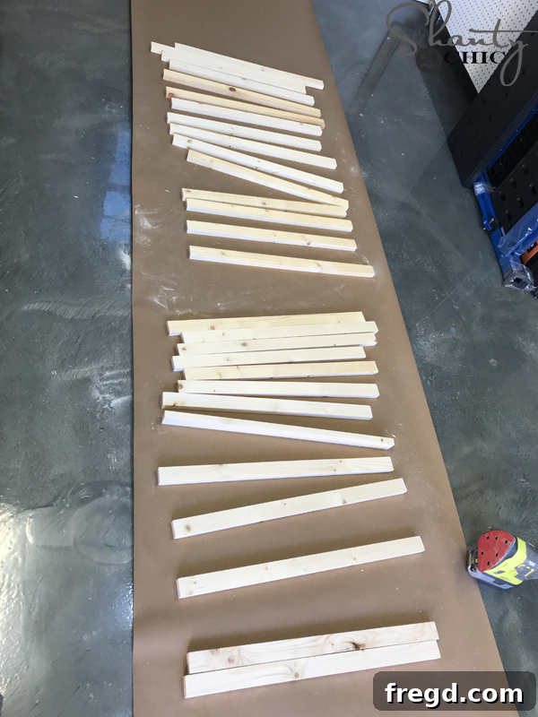 Applying the second coat of white paint to plywood for the cow print base