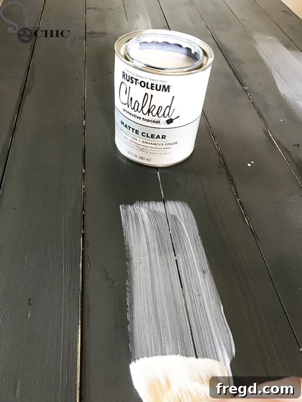 Applying Rust-Oleum Chalked spray paint in Charcoal to the DIY coffee table