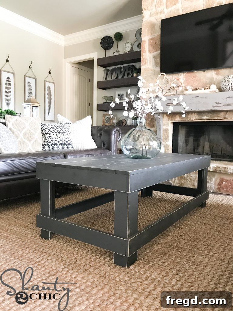 Close-up of coffee table decor, including a vase and botanical stems, complementing the table