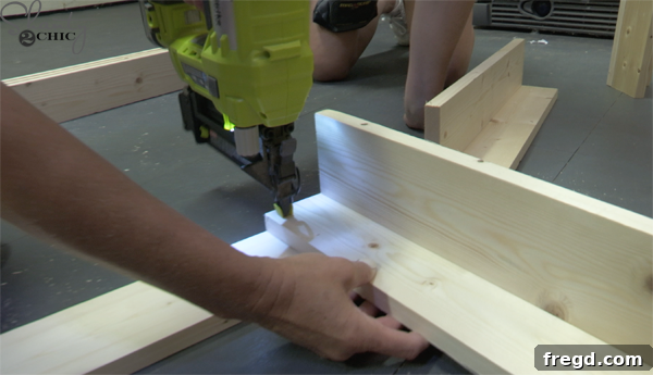 Assembling coffee table legs into an 'L' shape using wood glue and brad nails