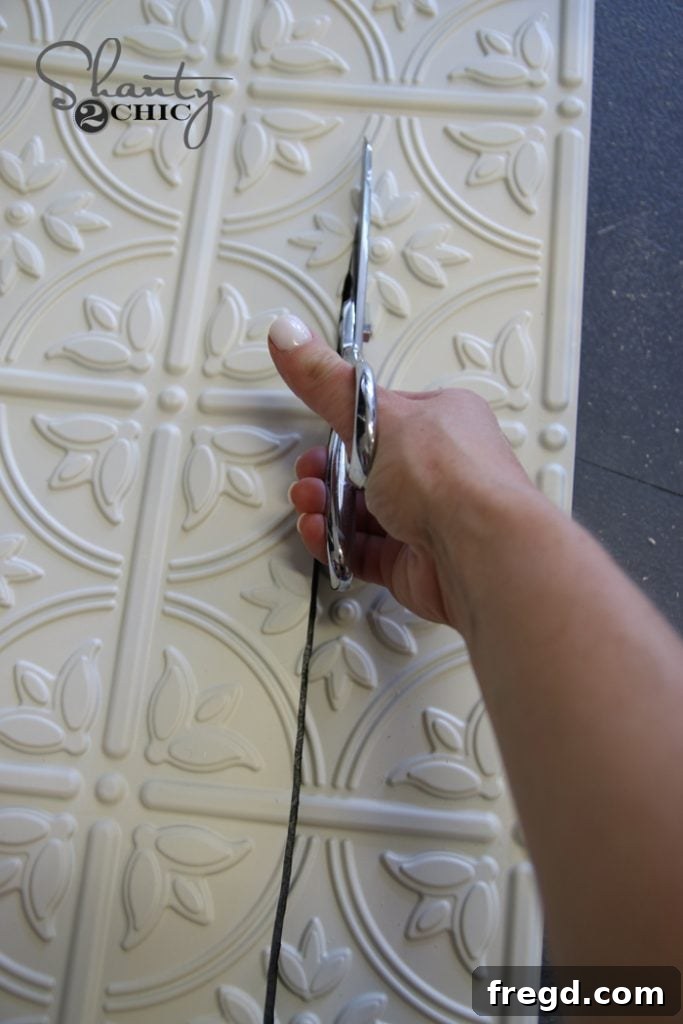 Preparing the faux tin panel for installation into the door frame