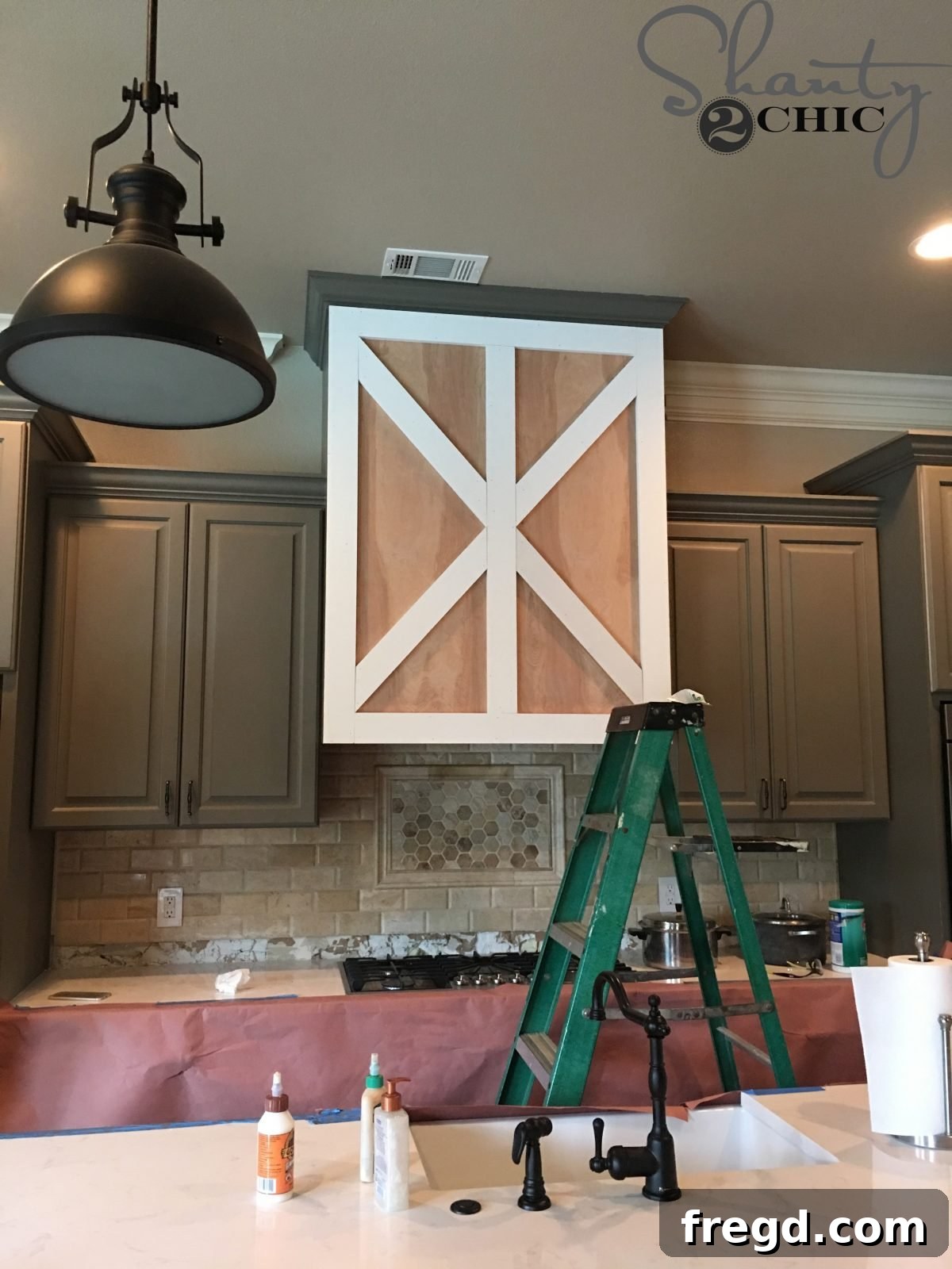 Craft Your Own Barn Door Range Hood 11 DIY Barn Door Vent Hood - Tutorial: Precisely cutting the diagonal trim pieces using a miter saw.