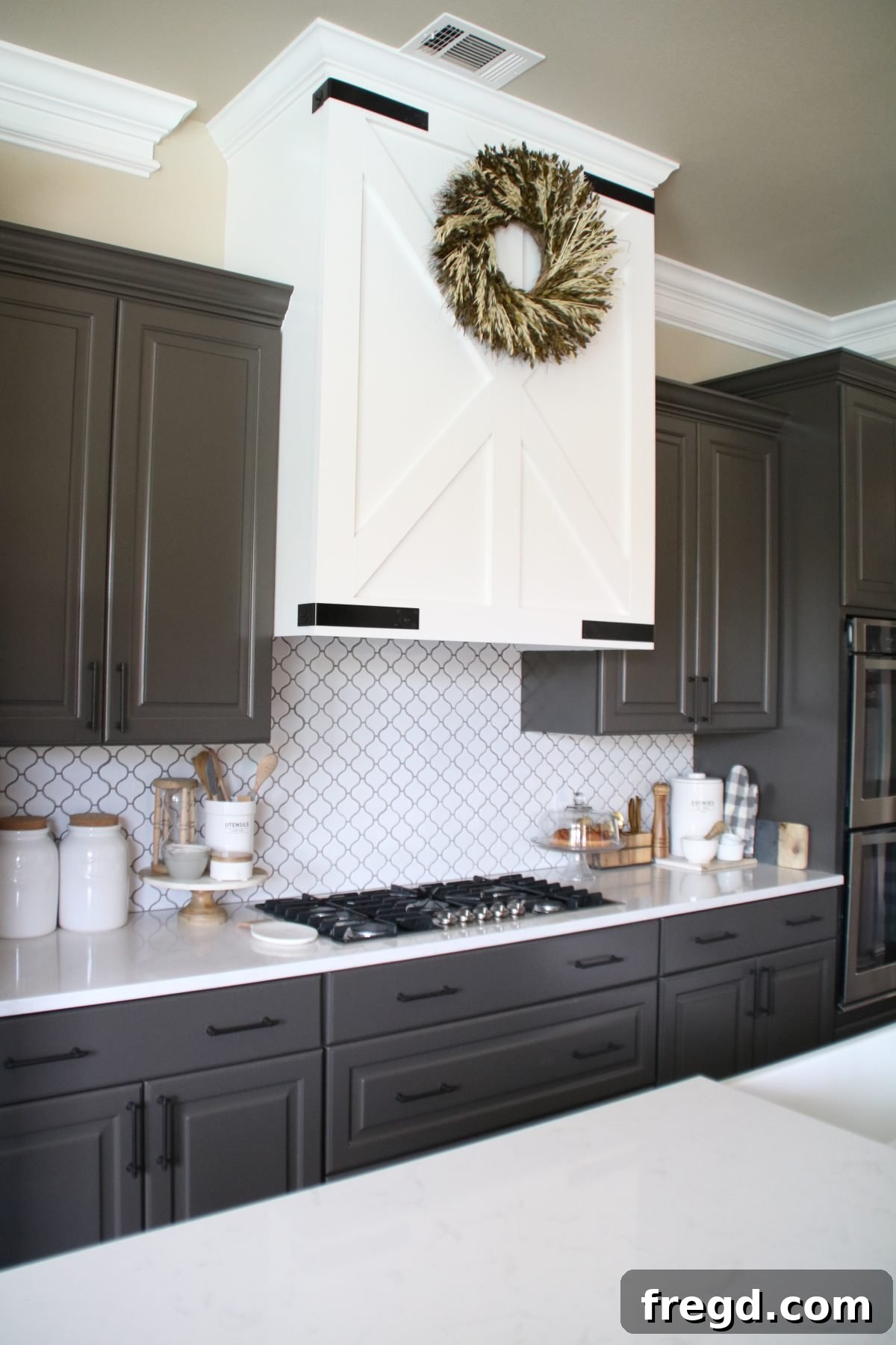 Craft Your Own Barn Door Range Hood 12 Completing the diagonal trim work on the DIY barn door vent hood with careful cuts and secure attachment.