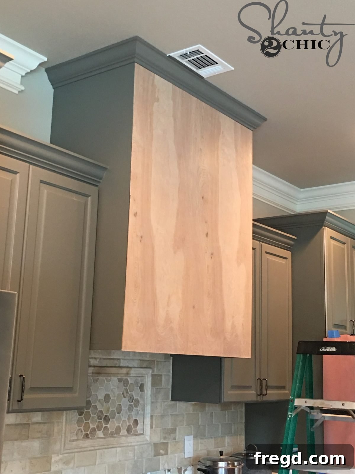 Craft Your Own Barn Door Range Hood 5 DIY Barn Door Vent Hood - Free Plans: Attaching the plywood base to the cabinet with brad nails and wood glue.