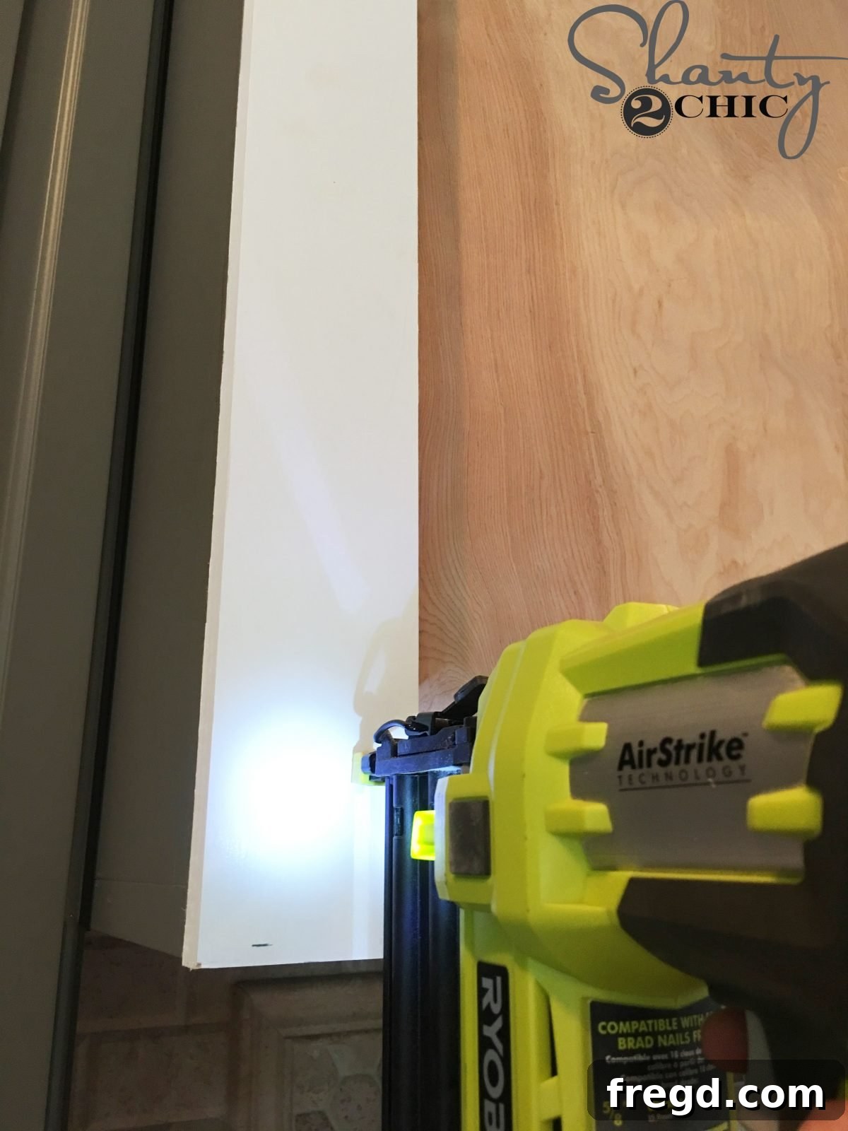 Craft Your Own Barn Door Range Hood 6 Starting the trim work for the DIY barn door vent hood with vertical 1x4 MDF boards.