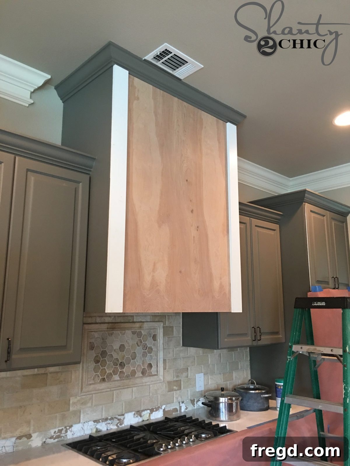 Craft Your Own Barn Door Range Hood 7 Attaching the vertical trim pieces to the cabinet, ensuring they are flush with the plywood edges.