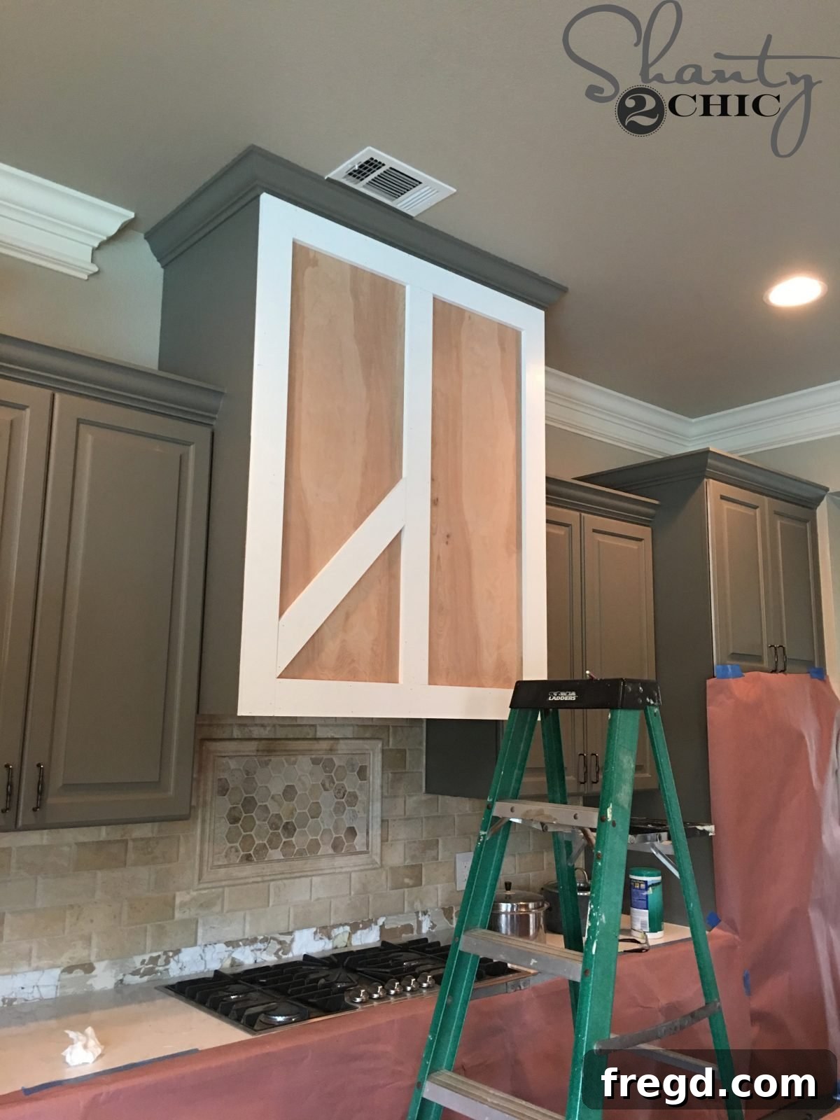 Craft Your Own Barn Door Range Hood 10 Attaching the middle vertical trim piece, defining the two barn door panels for the vent hood.