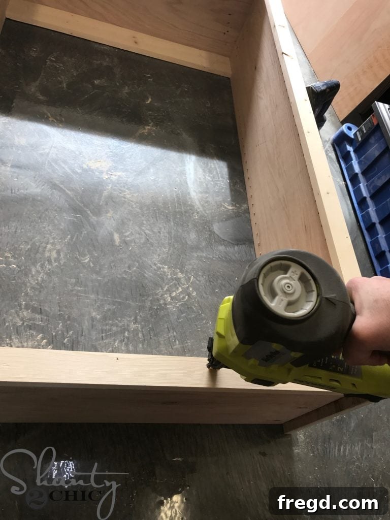 Applying wood glue to the front edges of the cabinet box for face frame