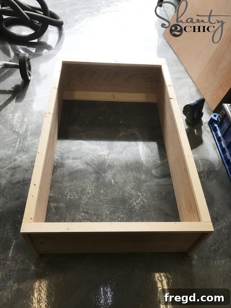 Attaching the face frame to the cabinet box using a nail gun