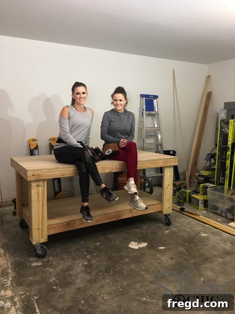 Crafting Your Ultimate Workspace 12 Proud builder standing next to the completed DIY workbench