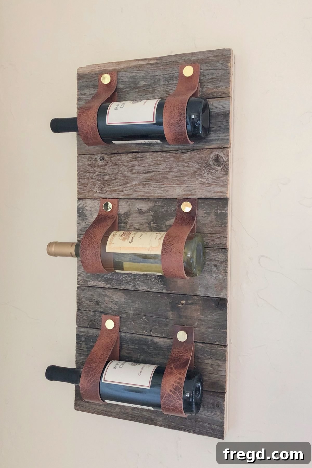 DIY Wood and Leather Wine Rack showcasing completed project with bottles