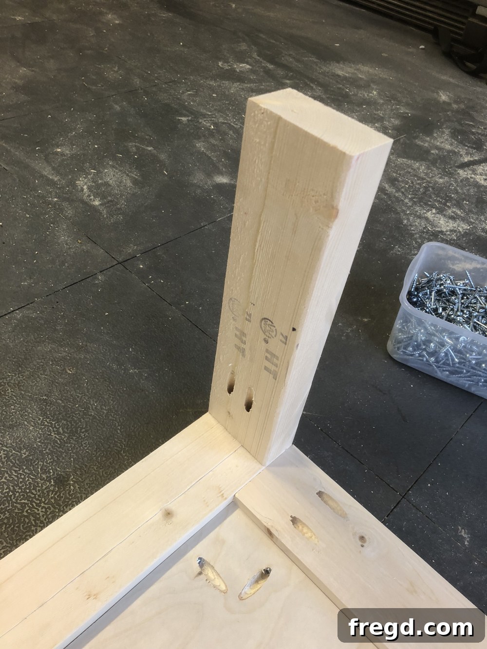 DIY Reclaimed Barn Wood Rolling Coffee Table 6 Close-up of a leg piece with a precisely drilled 1.5-inch pocket hole, prepared for secure attachment to the table top.