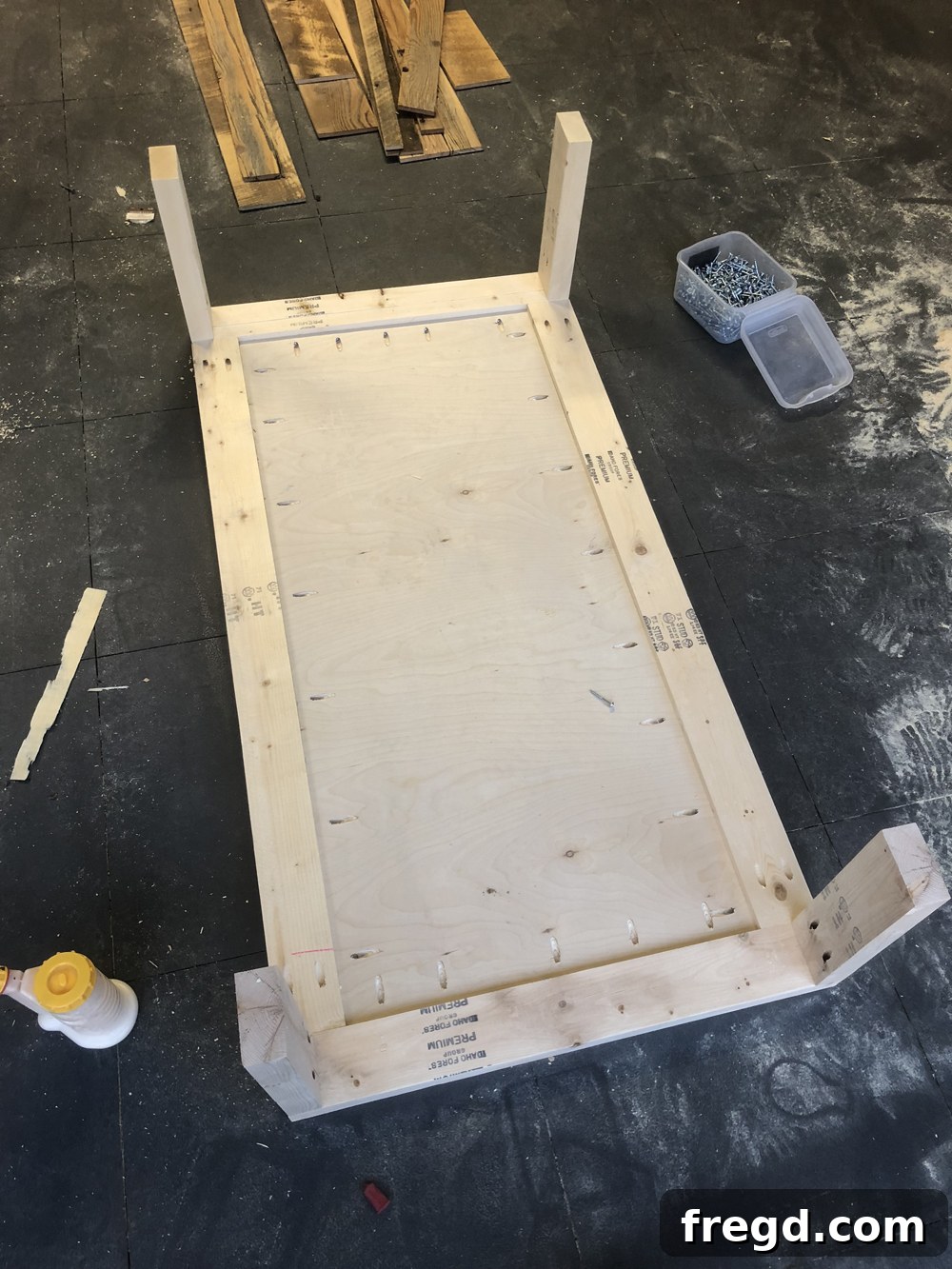DIY Reclaimed Barn Wood Rolling Coffee Table 7 Table legs securely attached to the top assembly, forming the basic structure and ready for the bottom shelf integration.