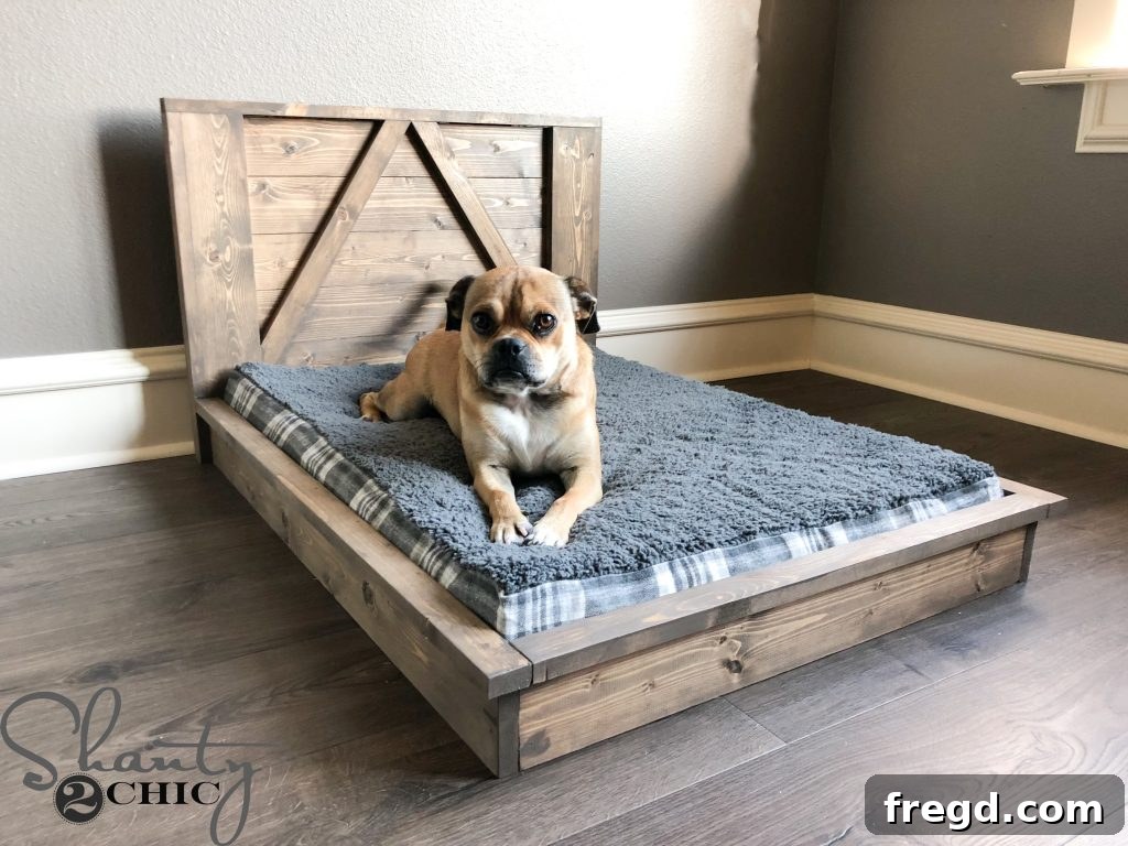 Dog mattress being placed into the finished DIY Farmhouse Dog Bed