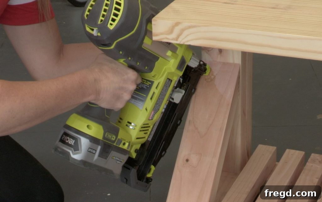 DIY Modern Farmhouse Entryway Organizer 15 Installing the slat pieces for the lower storage area