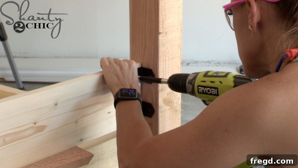 Installing wooden bed slats evenly spaced across the day bed frame