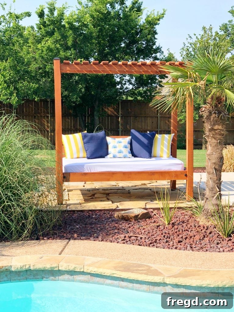 Close-up of the completed DIY outdoor day bed with mattress and decorative pillows