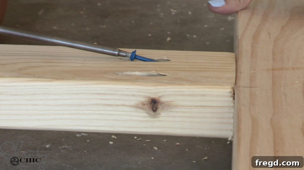 Using a Kreg Jig to drill pocket holes into wooden frame pieces for assembly