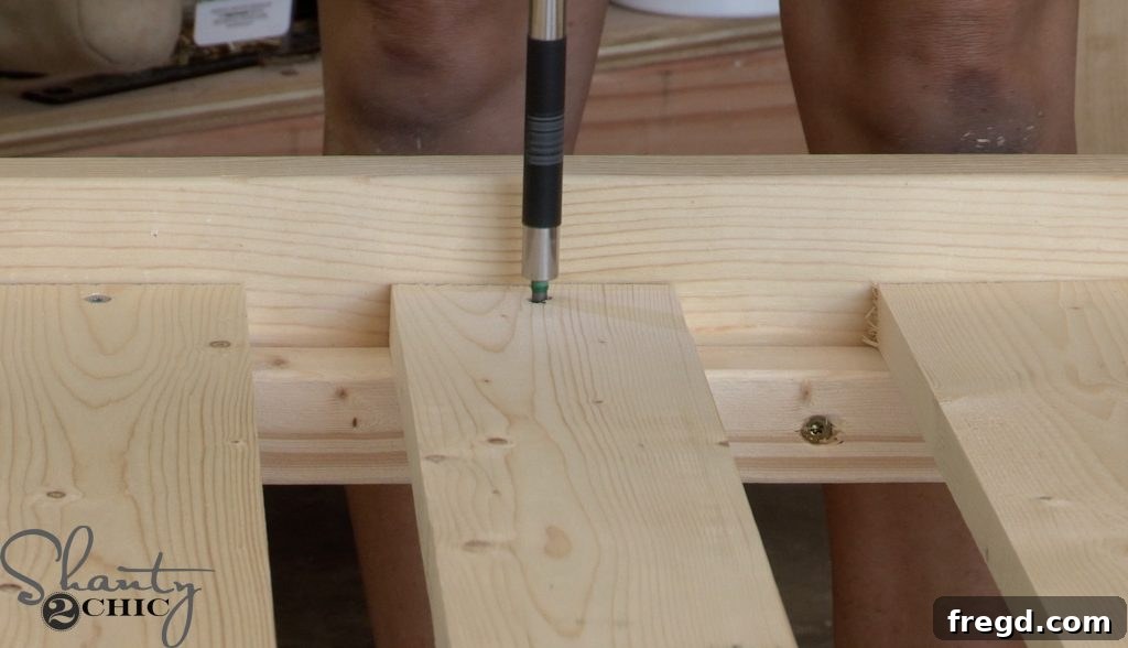 Securing the top back frame with metal angles and screws to the posts