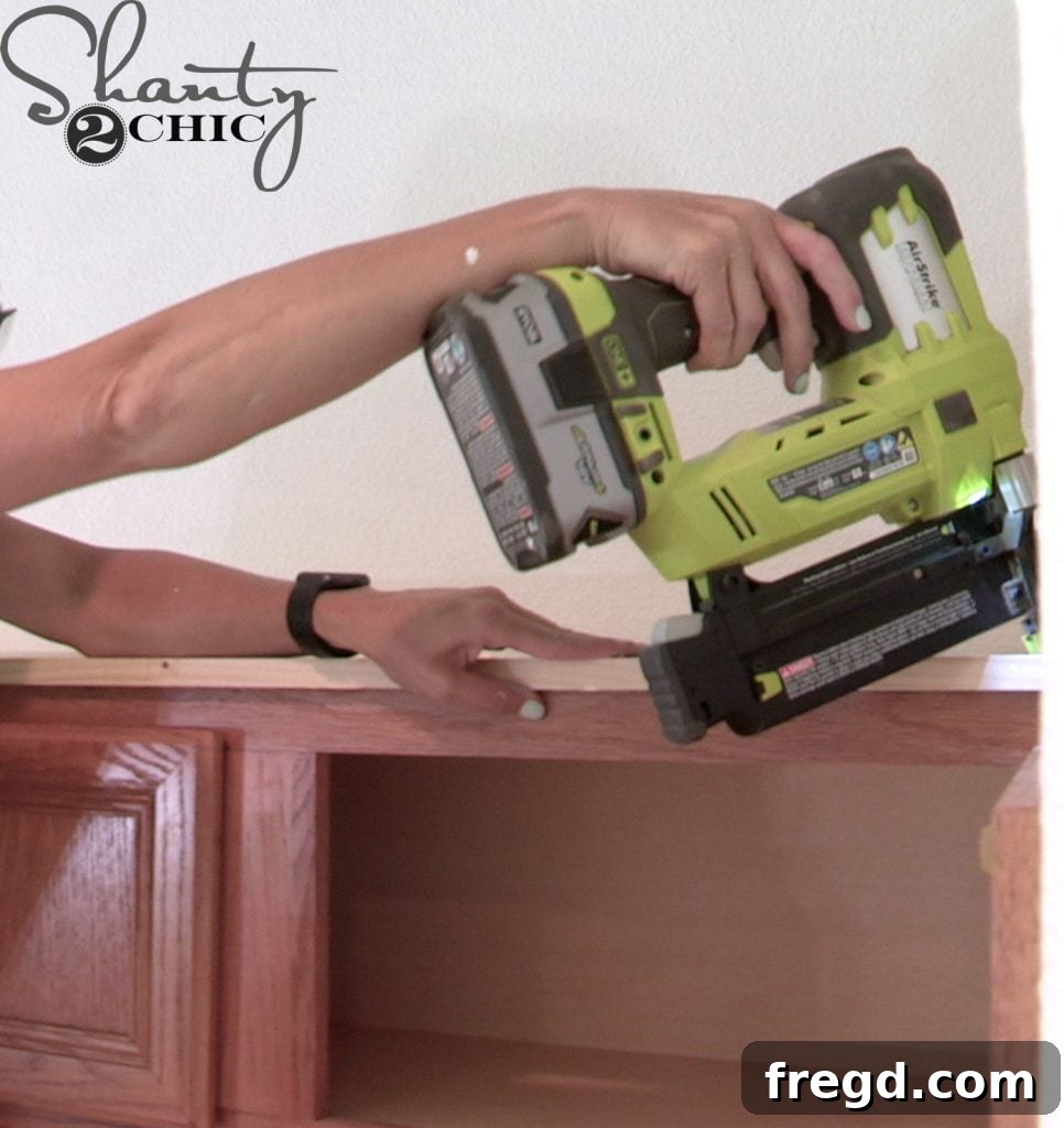 Removing old crown molding to prepare for taller cabinets