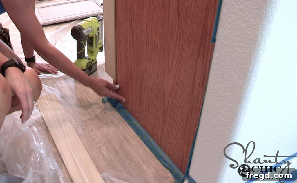 Custom trim piece being added to the toe kick area of a cabinet