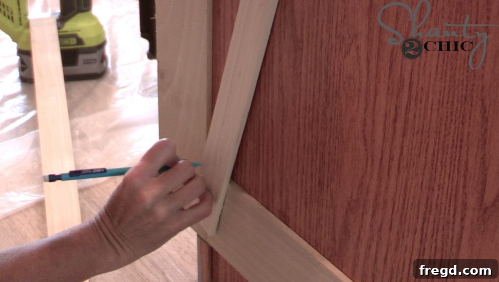 Measuring and cutting diagonal craft boards for a barn door trim design on cabinets