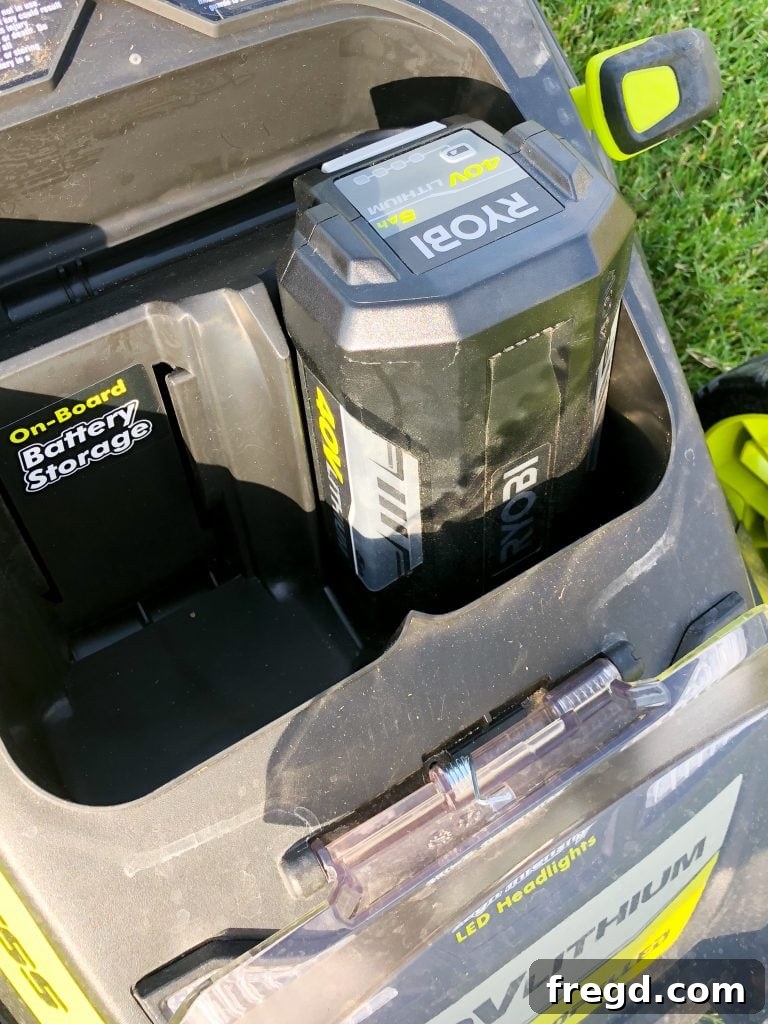 Close-up of the Ryobi 40V mower's battery compartment, highlighting its power source.