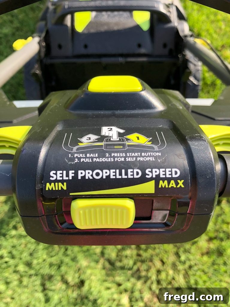 Person easily pushing the Ryobi 40V self-propelled mower in a lush green lawn.