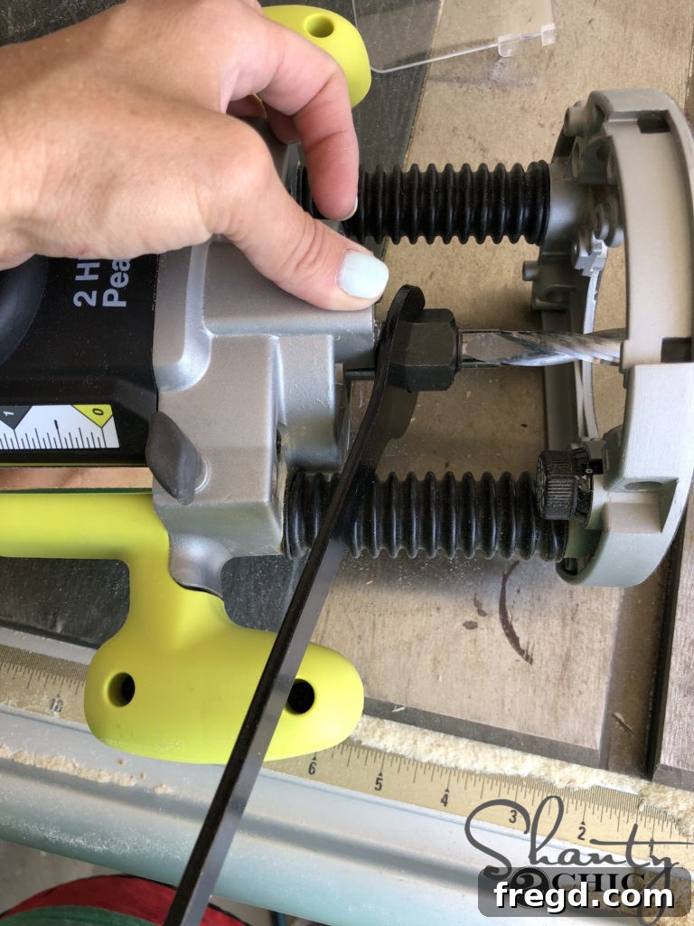 Using the specialized wrench to loosen the collet nut on the router for bit removal or insertion