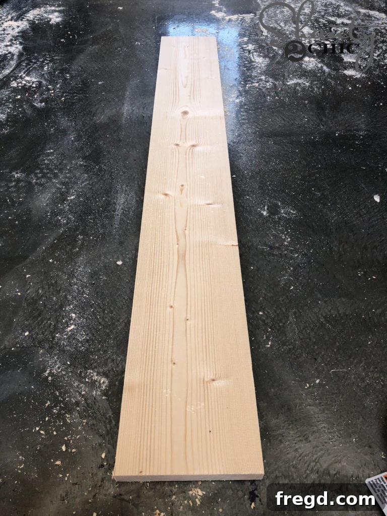 Measuring and cutting a 1x6 board to the specified length for the router jig's main arm