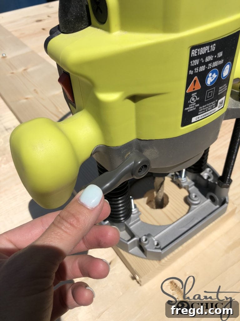 Demonstration of locking the plunge depth lever on the router for consistent cutting throughout the project